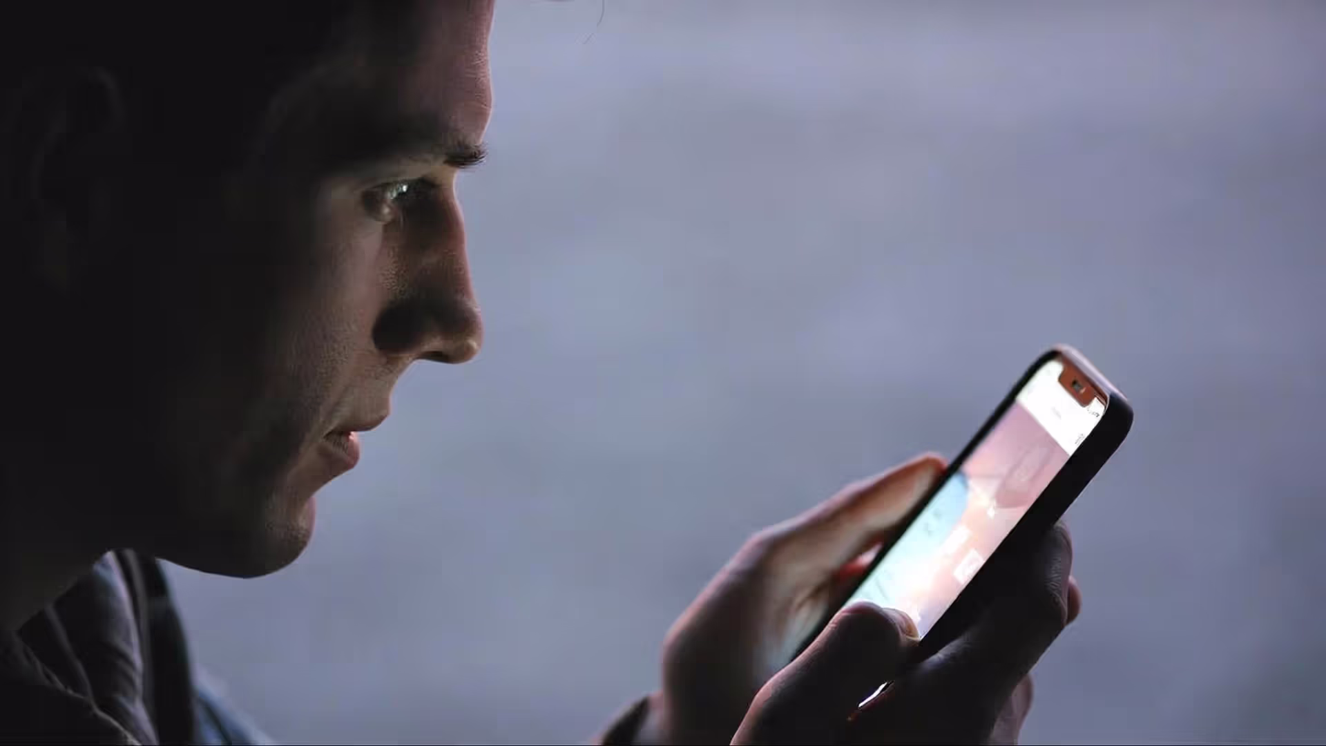 Person looking uncertain while reading messages on a phone